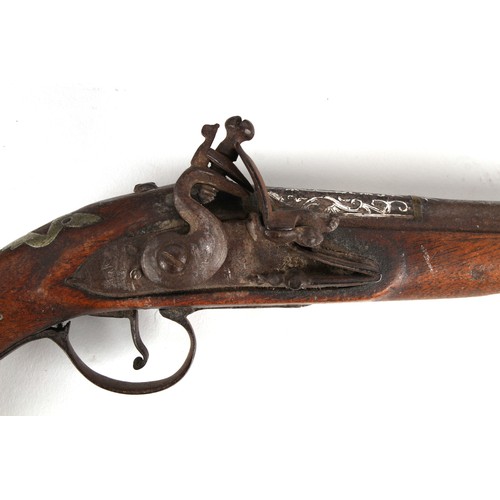 207 - Property of a lady - a large pair of 19th century Turkish flintlock pistols, the white metal mounts ... 