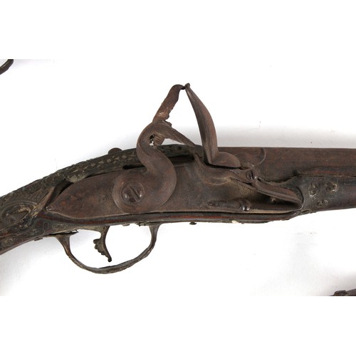 207 - Property of a lady - a large pair of 19th century Turkish flintlock pistols, the white metal mounts ... 