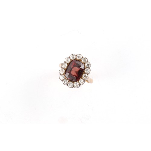 131 - A yellow gold almandine red spinel & diamond cluster ring, the oval cushion cut spinel weighing appr... 