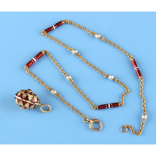 84 - A 14ct gold & red enamel egg pendant, the suspension ring marked '585' and б96 (Russian cyrillic let... 