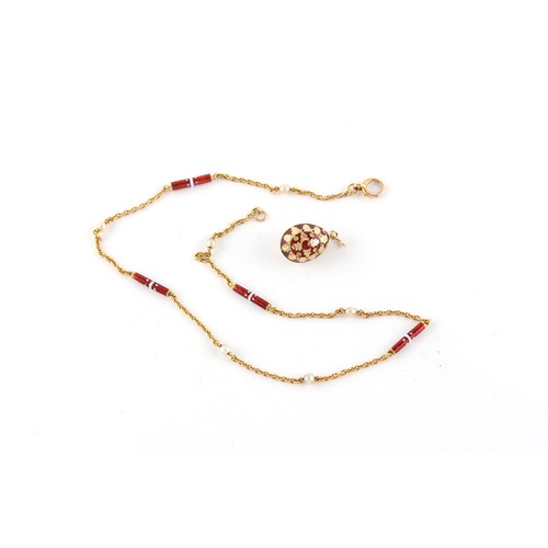 84 - A 14ct gold & red enamel egg pendant, the suspension ring marked '585' and б96 (Russian cyrillic let... 