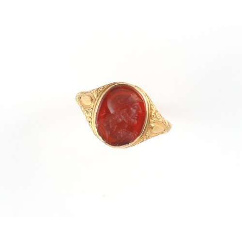 102 - An 18ct gold carved carnelian agate intaglio signet ring, the oval intaglio depicting a classical ma... 