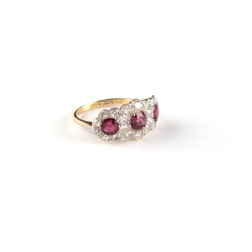 122 - An 18ct yellow gold ruby & diamond triple cluster ring, the three round cut rubies weighing a total ... 