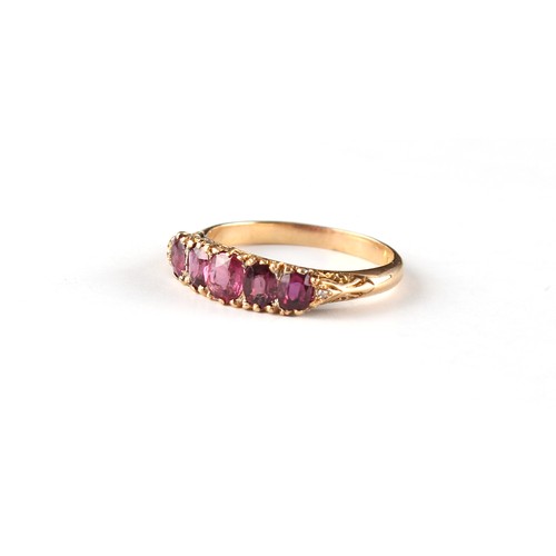 123 - An 18ct yellow gold ruby five stone ring, the estimated total ruby weight 0.70 carat, size M/N.