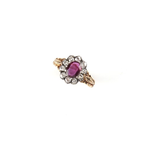 124 - A Victorian yellow gold ruby & diamond cluster ring, the oval cut ruby weighing approximately 1.06 c... 