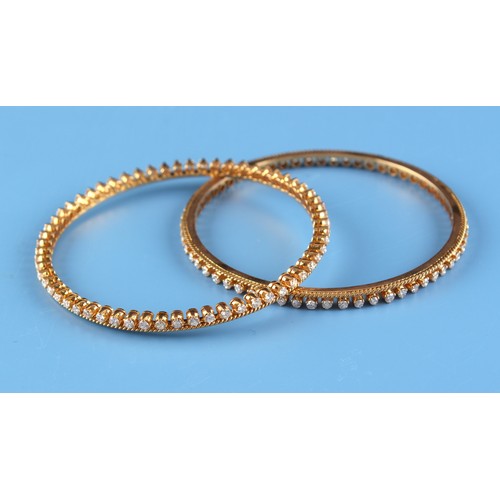 158 - A pair of unmarked yellow gold (test 18ct) diamond bangles, designed to be worn individually or side... 