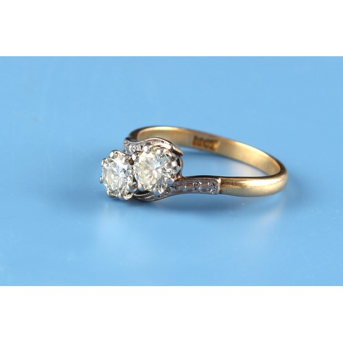 159 - An 18ct yellow gold diamond crossover ring, the estimated total diamond weight 0.64 carat, size J.