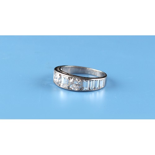 168 - A platinum diamond band ring, set with two round brilliant cut diamonds flanking a baguette cut diam... 