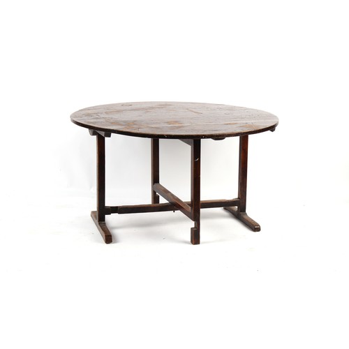 293 - Property of a lady - a 19th century fruitwood circular topped folding table, evidence of woodworm in... 