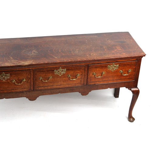 306 - Property of a lady - a mid 18th century George II / III oak dresser base with four fruitwood banded ... 