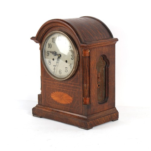 246A - Property of a gentleman - an early 20th century oak & inlaid arched cased mantel clock, the American... 