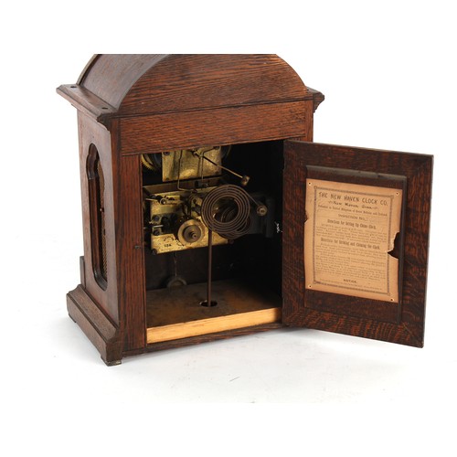 246A - Property of a gentleman - an early 20th century oak & inlaid arched cased mantel clock, the American... 