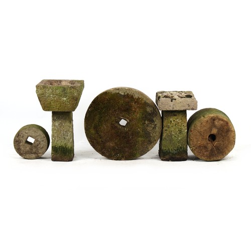 296 - Property of a lady - seven well-weathered antique stone garden items including mill wheels, the larg... 