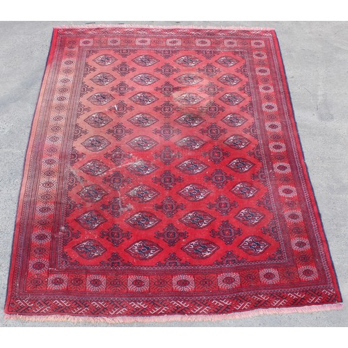 229 - Property of a deceased estate - a large Turkoman design hand-knotted wool rug, with red ground, 114 ... 