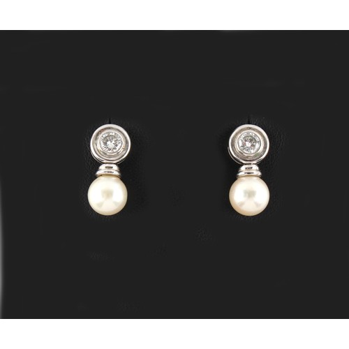 95 - Property of a lady - a pair of 18ct white gold diamond & pearl earrings, each with a round brilliant... 