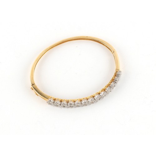 68 - Property of a lady - a 14ct yellow gold diamond hinged bangle, four diamonds missing, the estimated ... 