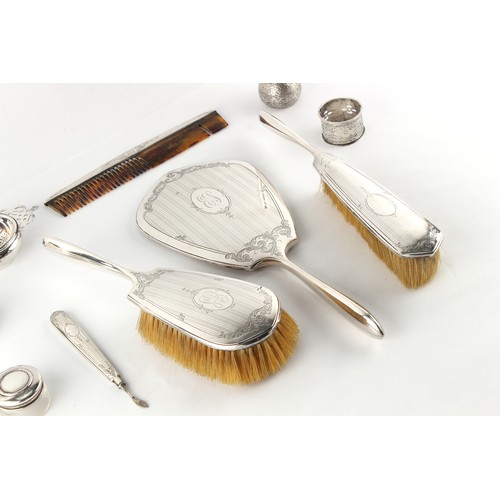 226 - Property of a lady - an American Birks sterling silver four piece hand mirror & brush set; together ... 