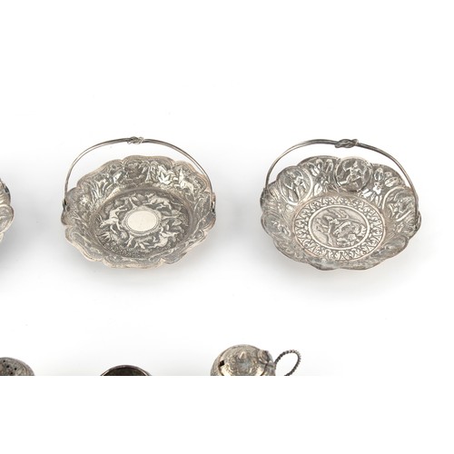 228 - Property of a lady - a pair of Indian unmarked silver (tested) small baskets, with swing handles, ea... 