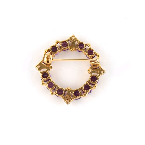 81 - Property of a lady - a 15ct yellow gold wreath brooch set with round cut purple gemstones, probably ... 