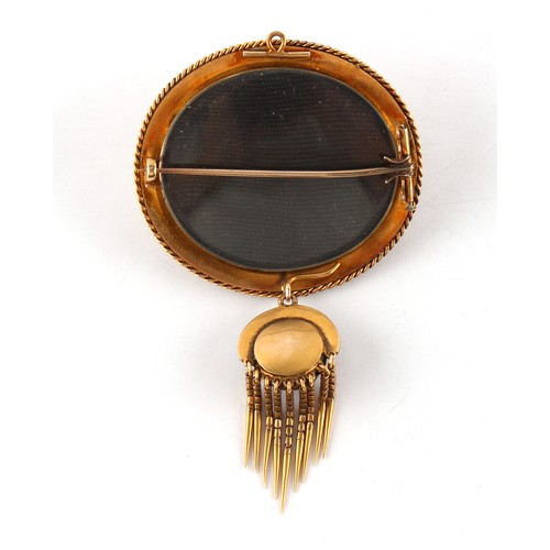 149 - A Victorian unmarked gold cabochon garnet & seed pearl articulated oval brooch with fringe, with fol... 