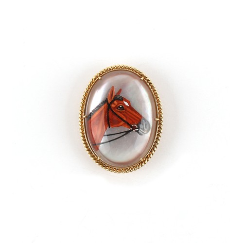 107 - An unmarked yellow gold (tests 14ct) oval framed Essex crystal horse brooch, 34mm long.