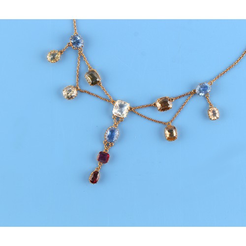 124 - A multi gem set festoon necklace, with an octagonal cut ruby, three cornflower blue sapphires, yello... 