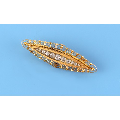 82 - A late 19th / early 20th century 15ct gold & diamond navette shaped brooch with scrollwork border, s... 