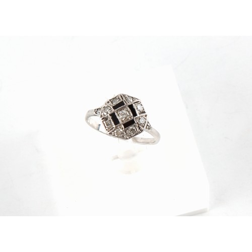 105 - An early 20th century Art Deco white gold or platinum black onyx & diamond octagonal panel ring, siz... 