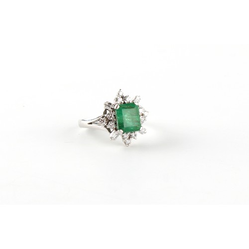 120 - An 18ct white gold emerald and diamond cluster ring, the emerald weighing approximately 2.53 carats,... 