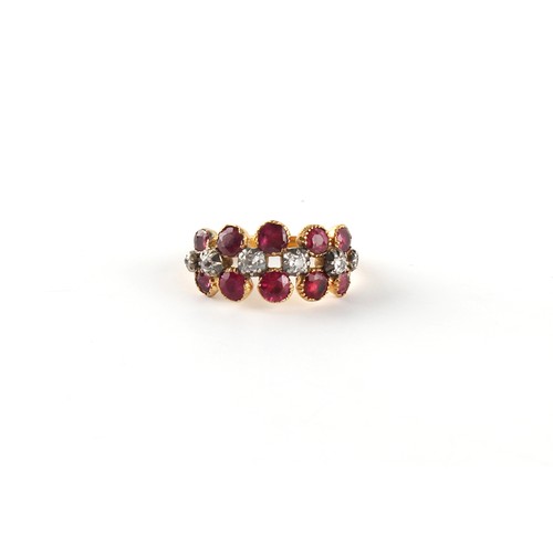 145 - A Georgian ruby & diamond ring, the ten round cut rubies in closed back collets, flanking six diamon... 