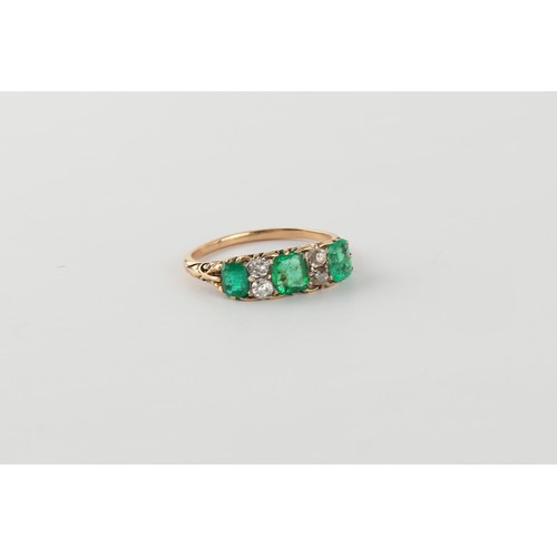 123 - A yellow gold emerald & diamond seven stone ring, the three emeralds of good colour and weighing app... 