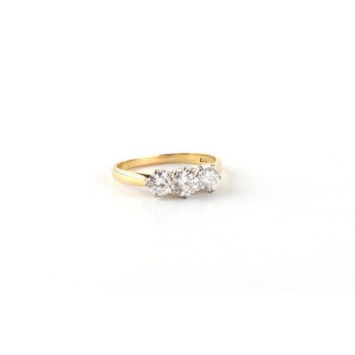 94 - An 18ct yellow gold diamond three stone ring, the round brilliant cut diamonds weighing a total of a... 