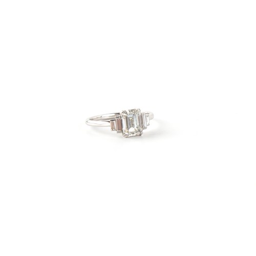 143 - A fine Art Deco style diamond ring, the centre certificated emerald cut diamond weighing approximate... 