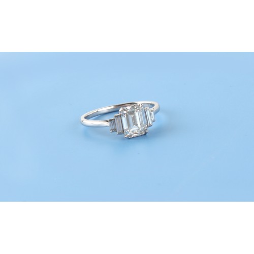 143 - A fine Art Deco style diamond ring, the centre certificated emerald cut diamond weighing approximate... 