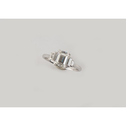 143 - A fine Art Deco style diamond ring, the centre certificated emerald cut diamond weighing approximate... 