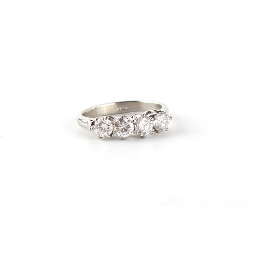 73 - A platinum diamond four stone ring, the round brilliant cut diamonds weighing approximately 1.15 car... 