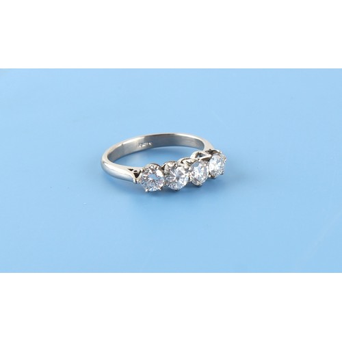 73 - A platinum diamond four stone ring, the round brilliant cut diamonds weighing approximately 1.15 car... 