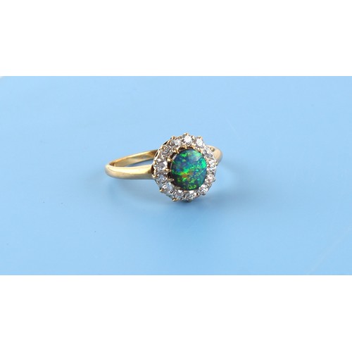 100 - An 18ct yellow gold black opal & diamond round cluster ring, the black opal weighing approximately 0... 