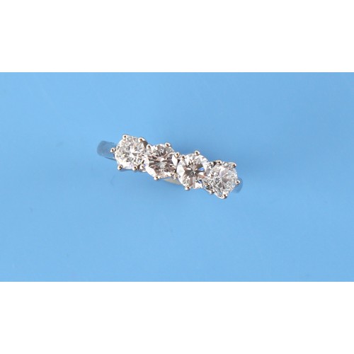 114 - A platinum diamond four stone ring, the round brilliant cut diamonds weighing a total of approximate... 