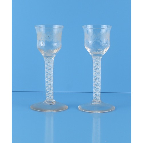 2 - Property of a gentleman - a pair of George III opaque twist cordial glasses, the ogee bowls with eng... 