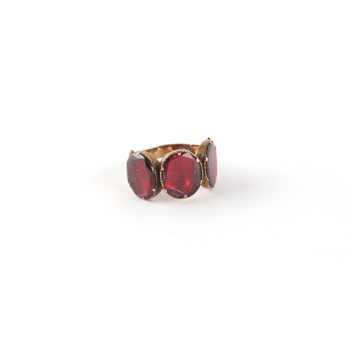 163 - Property of a lady - a Georgian unmarked gold garnet three stone ring, the garnets approximately 9 x... 