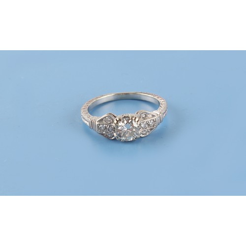 144 - Property of a lady - an Art Deco style 18ct white gold diamond ring, the centre round brilliant cut ... 