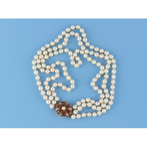 73 - Property of a lady - a cultured pearl three strand necklace, the uniform pearls approximately 6mmm d... 