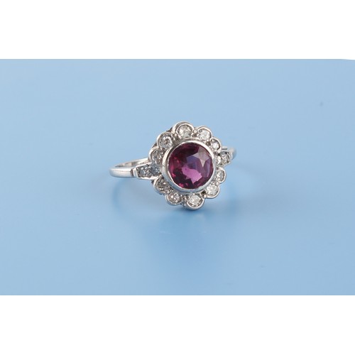 152 - An 18ct white gold ruby & diamond floral cluster ring, the certificated Thai unheated round cut ruby... 