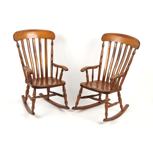 352 - Property of a deceased estate - a pair of Victorian elm seated lath-back rocking chairs, maker's sta... 