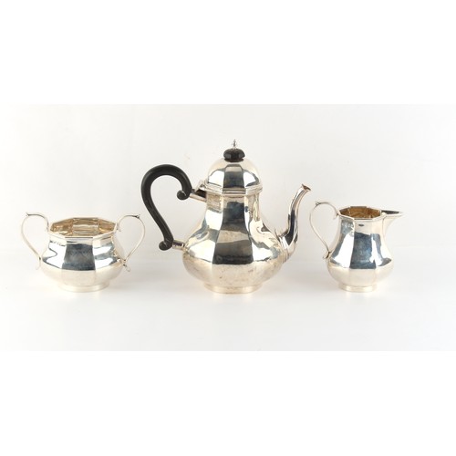 228 - Property of a deceased estate - an Art Deco silver three piece tea set, of octagonal baluster form, ... 