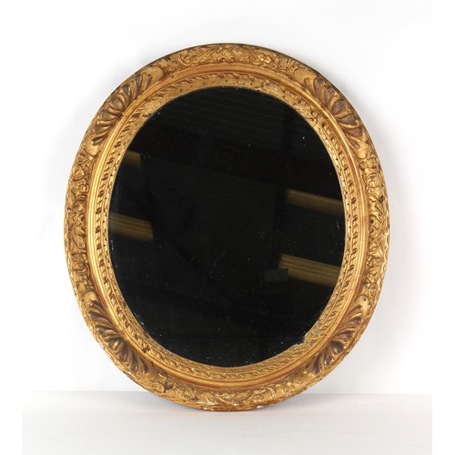 352 - Property of a lady of title - a large late Victorian giltwood oval framed wall mirror, 38 by 33.5ins... 