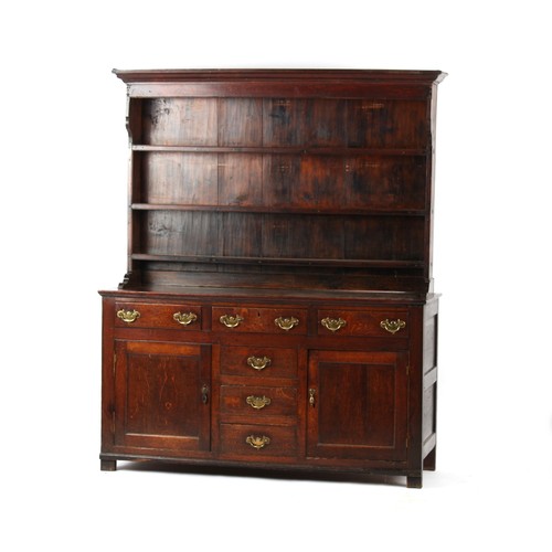 411 - An 18th century George III oak two-part dresser, of good colour, the base with a bank of four centra... 