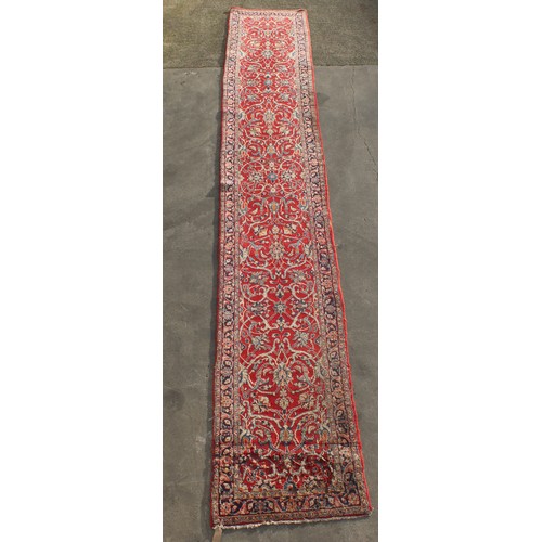 305 - Property of a deceased estate - a Persian hand-knotted wool long runner, old moth damage to one end,... 