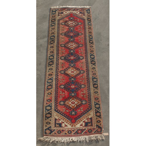 307 - Property of a deceased estate - a Persian hand-knotted wool runner, 109 by 33ins. (277 by 84cms.).